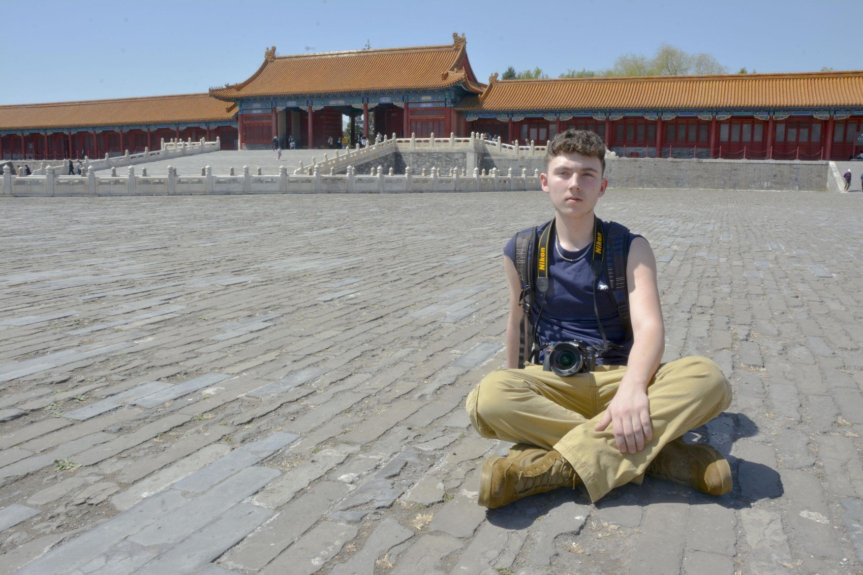 A member of the Student Study Tour takes a picture in front of a Chinese temple.